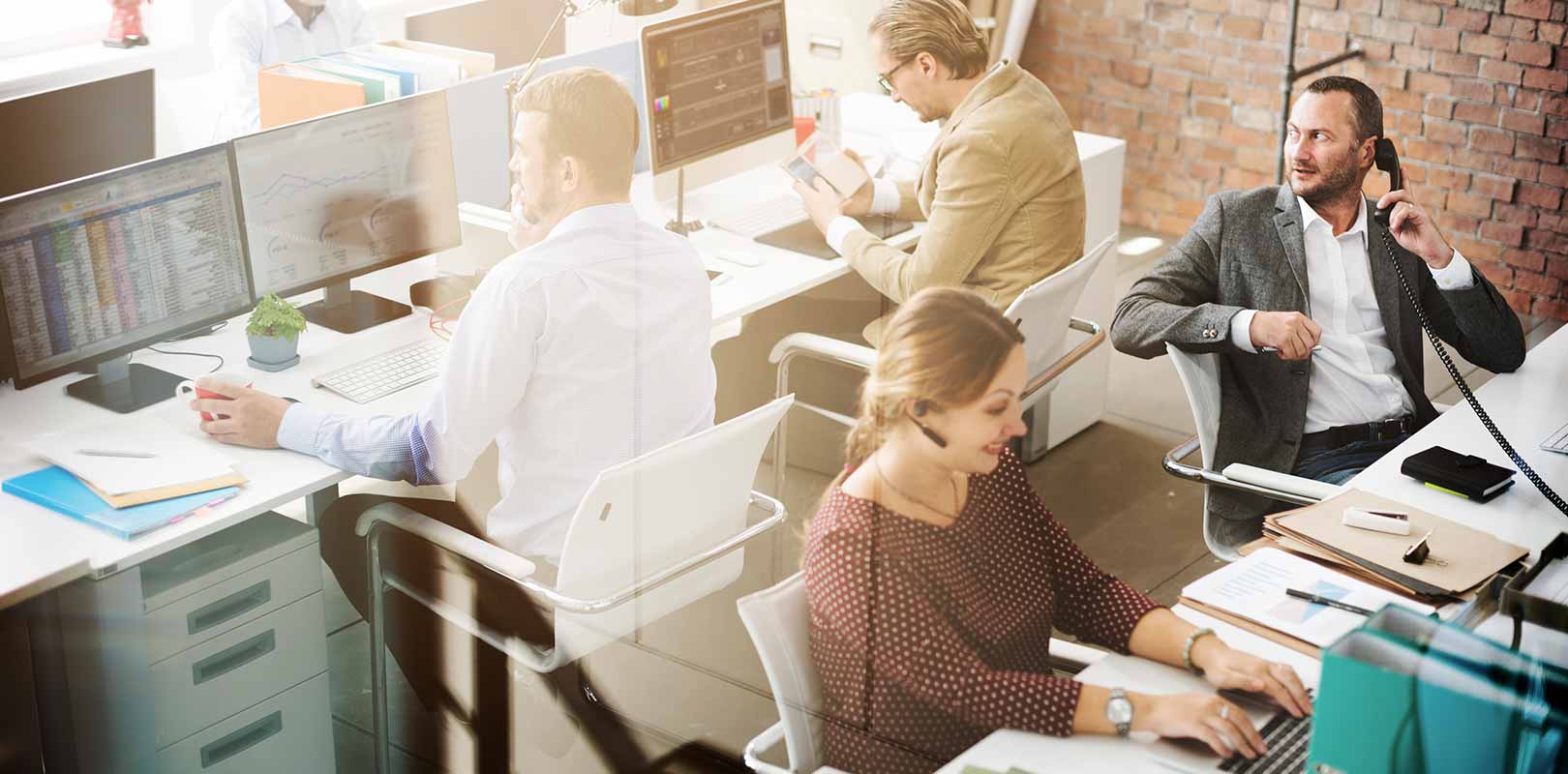 A photo of a busy office with computers and other office equipment