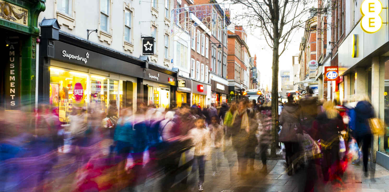 People walking down a busy high street