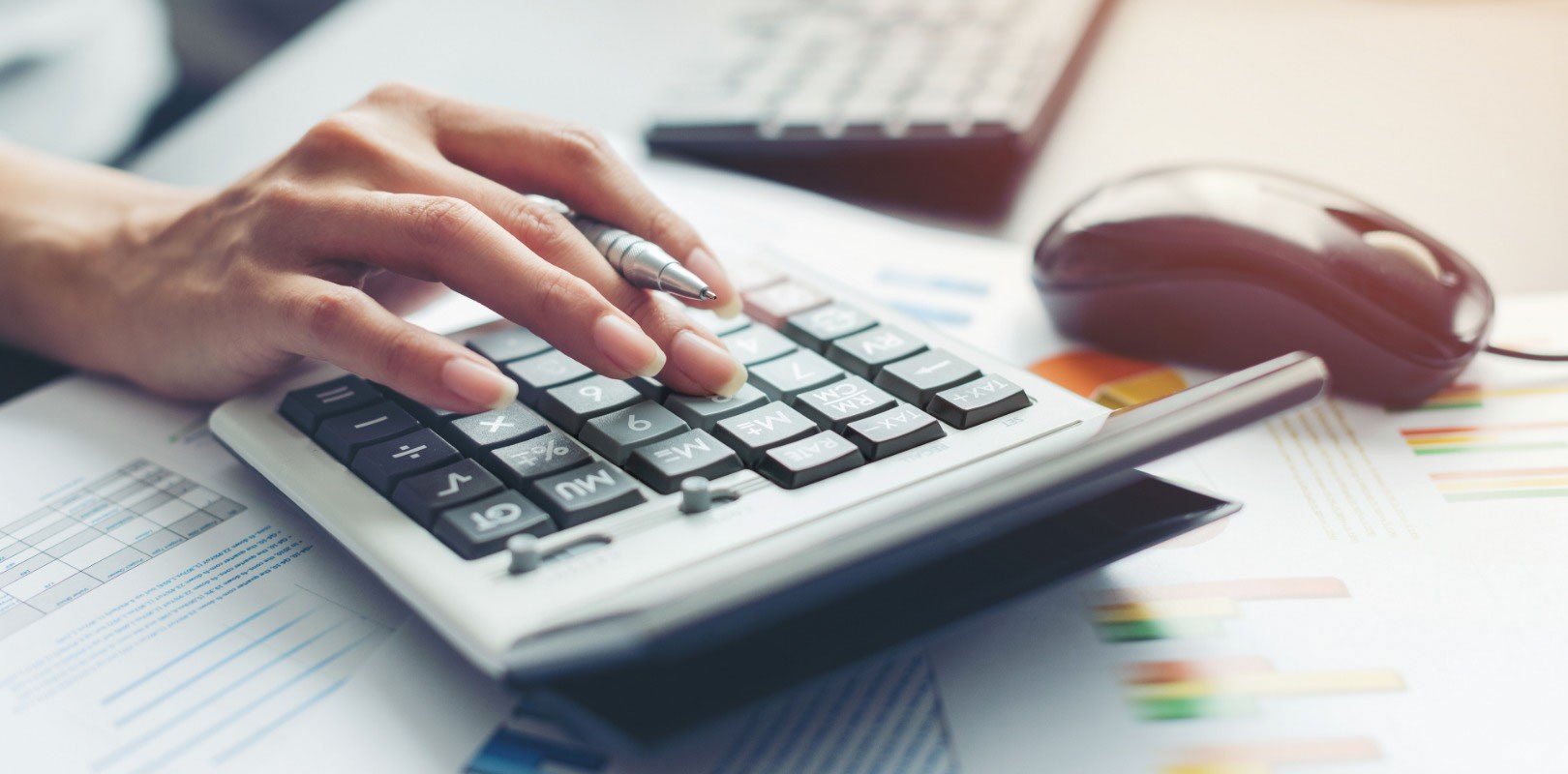 Person using a calculator to work out finances